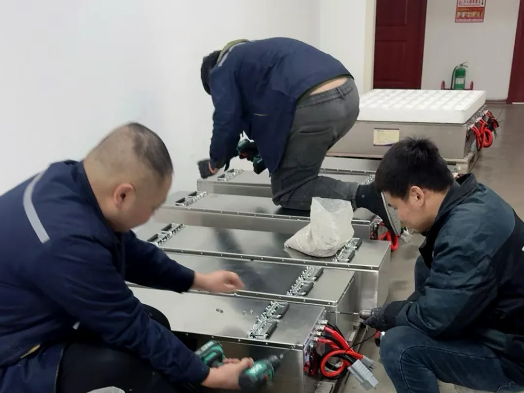 Technicians assembling custom lithium battery packs in the workshop